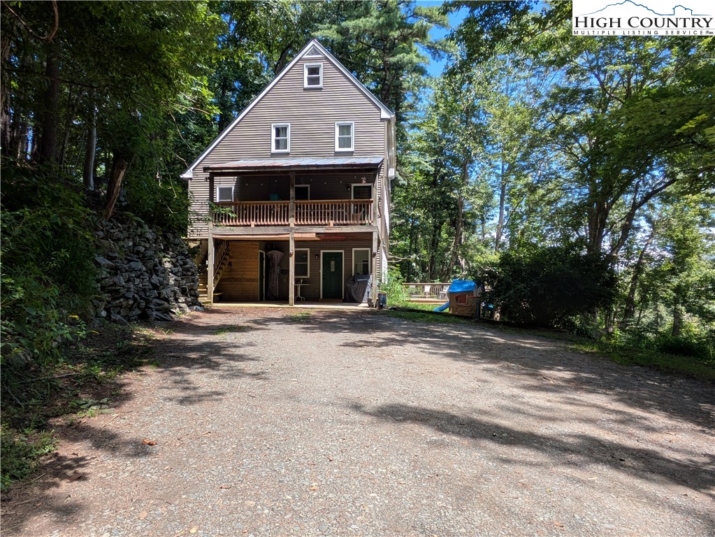 a front view of a house with a yard garage and outdoor seating