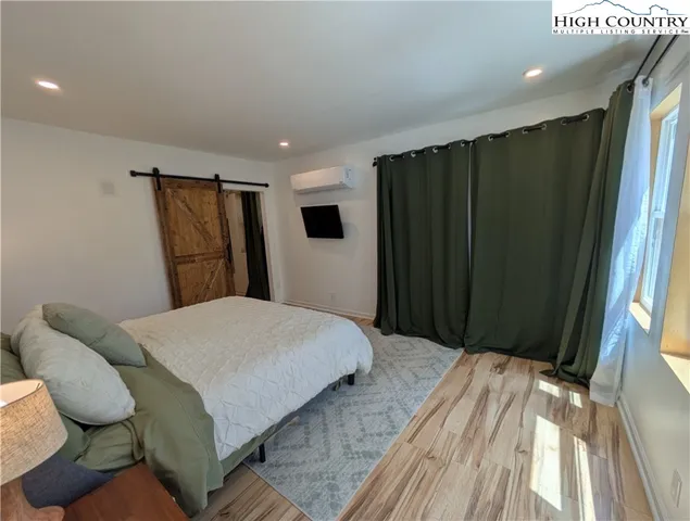 a bedroom with a bed and a mirror