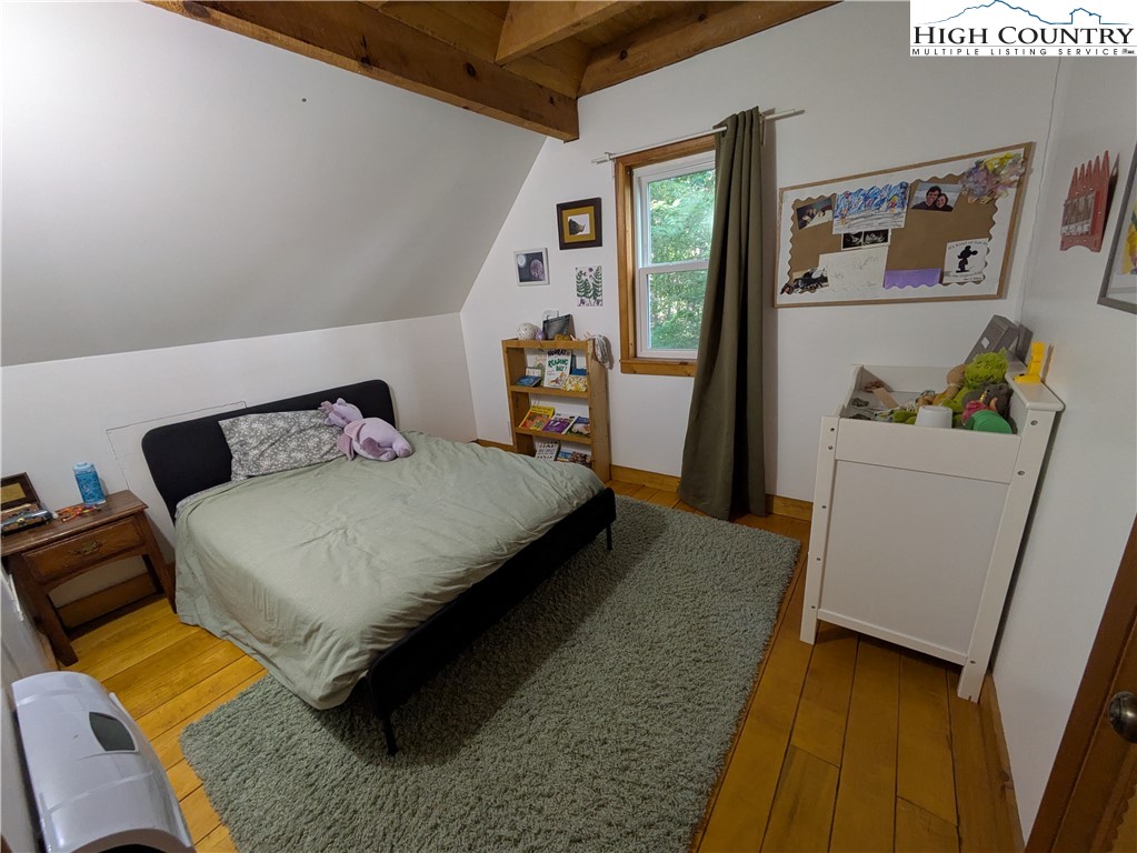 399 Ravens Ridge Circle Boone, NC 28607 - Photo 20 of 42 a bedroom with a bed and a refrigerator