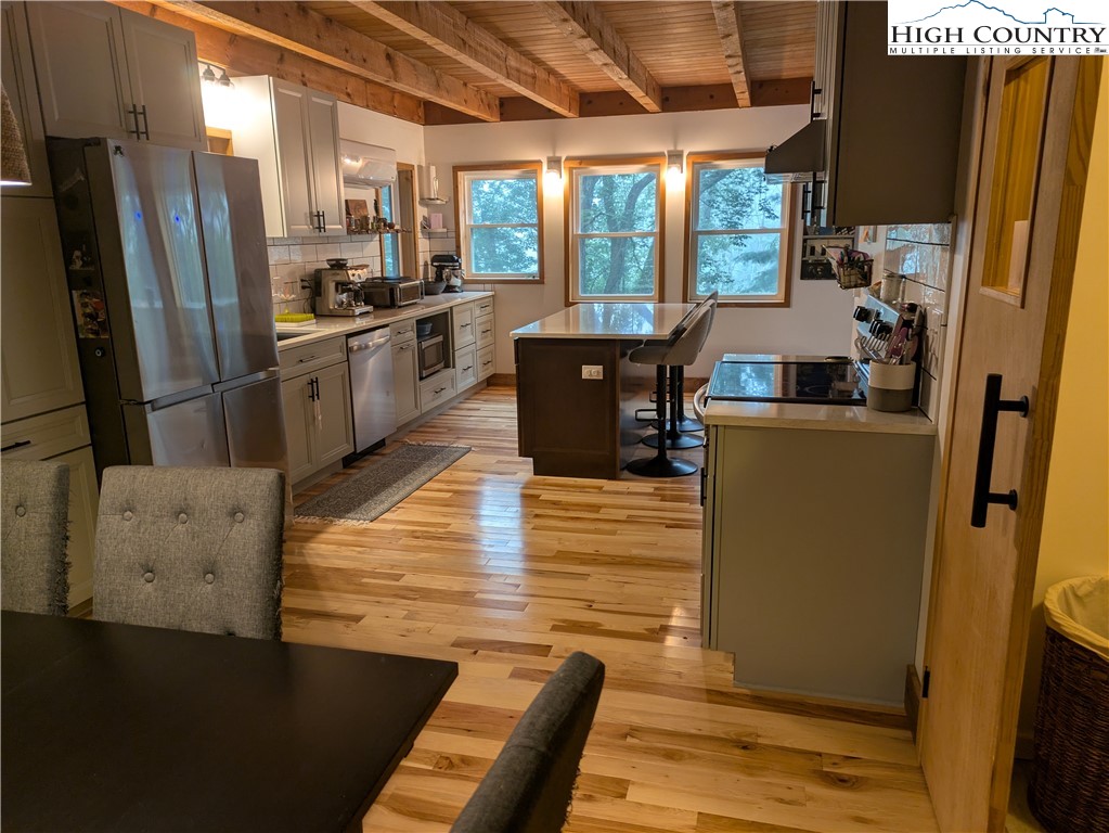 399 Ravens Ridge Circle Boone, NC 28607 - Photo 2 of 42 a kitchen with stainless steel appliances a refrigerator a stove a sink a dining table and chairs