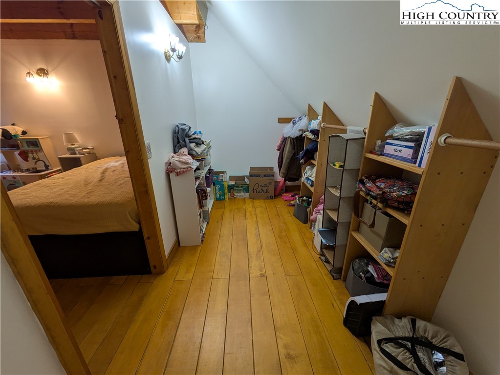 399 Ravens Ridge Circle Boone, NC 28607 - Photo 25 of 42 a bed sitting in a bedroom next to a window