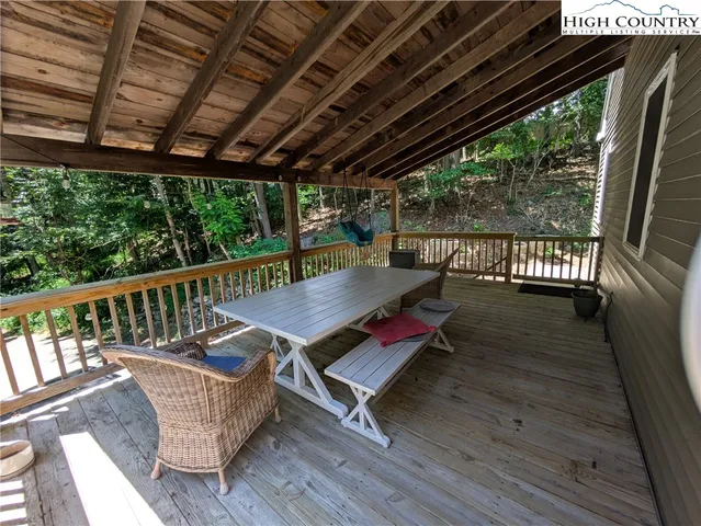 a view of balcony with wooden floor and outdoor seating