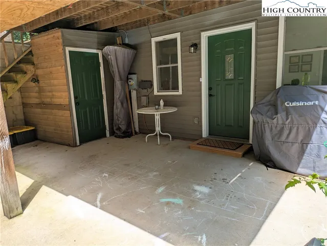 a view of a house with parking space and a tub