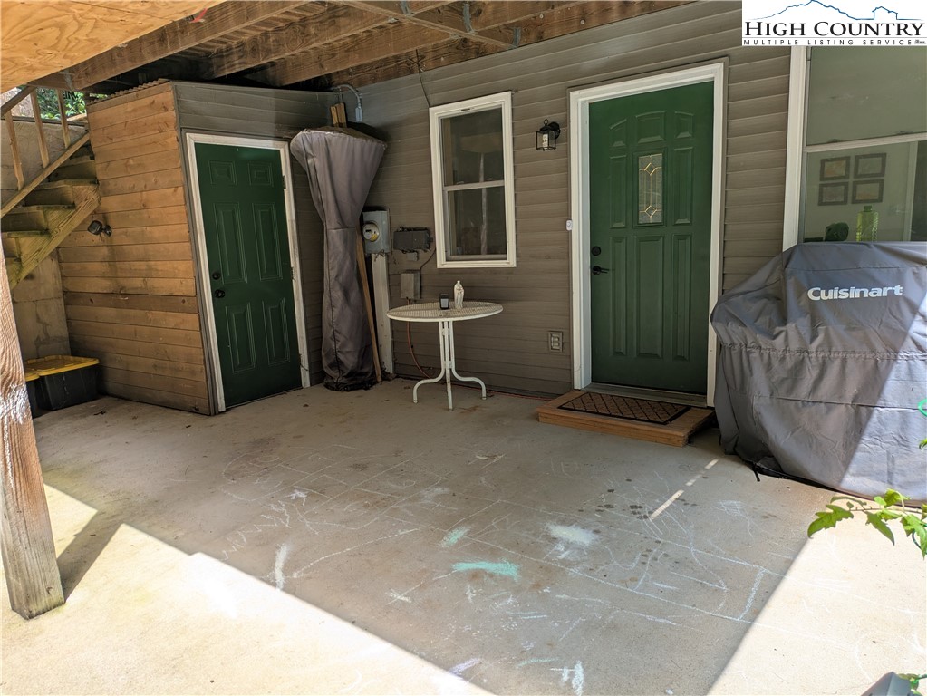 399 Ravens Ridge Circle Boone, NC 28607 - Photo 32 of 42 a view of a house with parking space and a tub