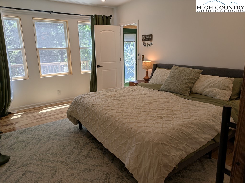 399 Ravens Ridge Circle Boone, NC 28607 - Photo 10 of 42 a bedroom with a bed and wooden floor