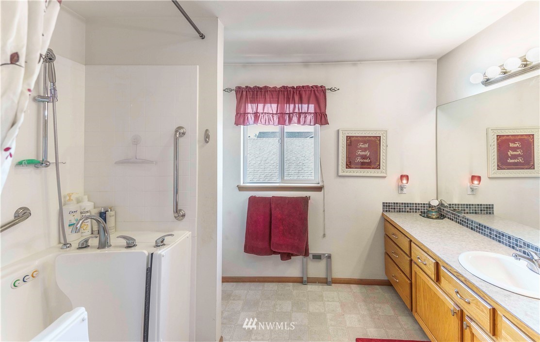 4139 Track Street Bellingham, WA 98226 - Photo 23 of 40 a bathroom with a tub sink vanity and mirror