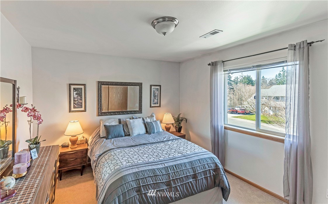 4139 Track Street Bellingham, WA 98226 - Photo 28 of 40 a bedroom with a bed and wooden floor