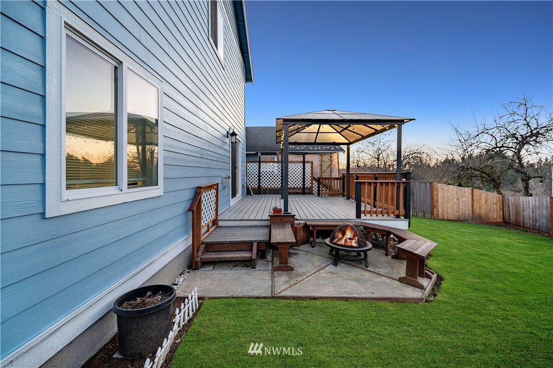 4139 Track Street Bellingham, WA 98226 - Photo 33 of 40 a view of a backyard with chairs potted plants and a wooden fence