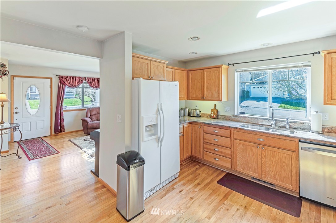 4139 Track Street Bellingham, WA 98226 - Photo 7 of 40 a kitchen with stainless steel appliances granite countertop a refrigerator a stove and a sink