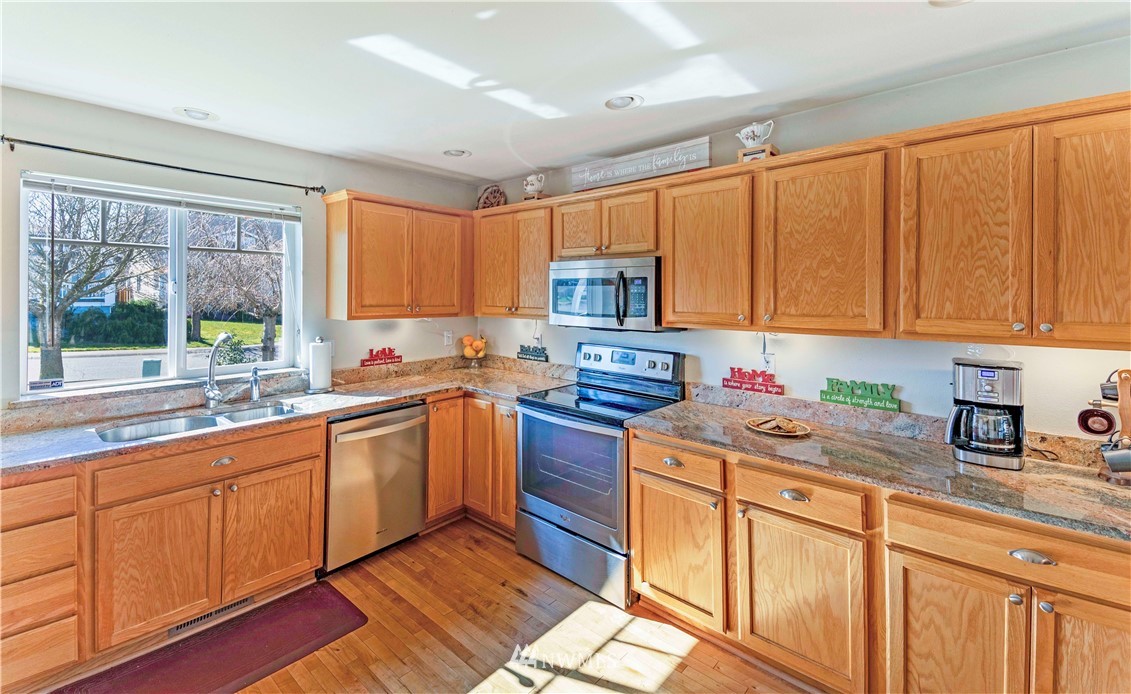 4139 Track Street Bellingham, WA 98226 - Photo 8 of 40 a kitchen with stainless steel appliances granite countertop a sink stove and cabinets