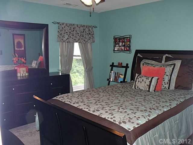 189 Mott Road Mooresville, NC 28115 - Photo 14 of 16 a bed sitting in a bedroom next to a window with a dresser
