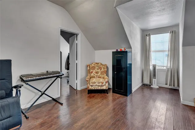 a view of an entryway with wooden floor and livingroom