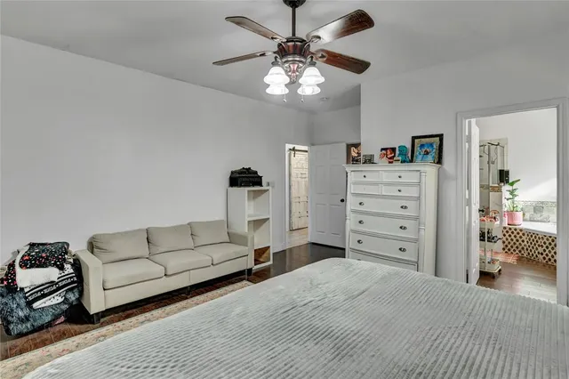 a spacious bedroom with a bed and a chandelier