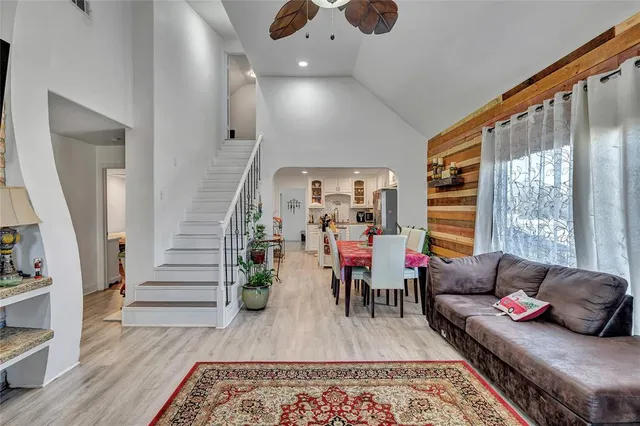a living room with furniture and wooden floor