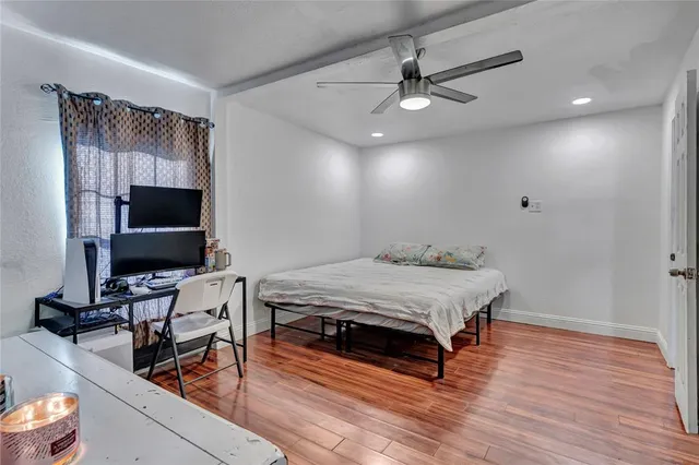 a bedroom with furniture and flat screen tv