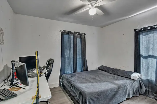a bedroom with bed and a chandelier