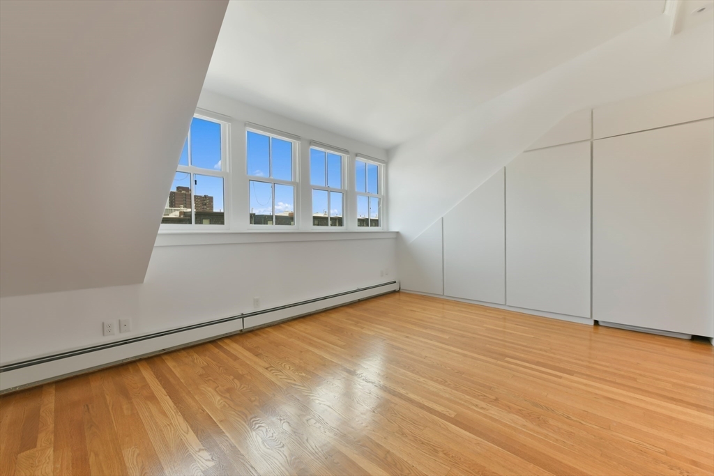 71 Rutland Street, Unit 4 Boston, MA 02118 - Photo 20 of 35 a view of a room with wooden floor and a window