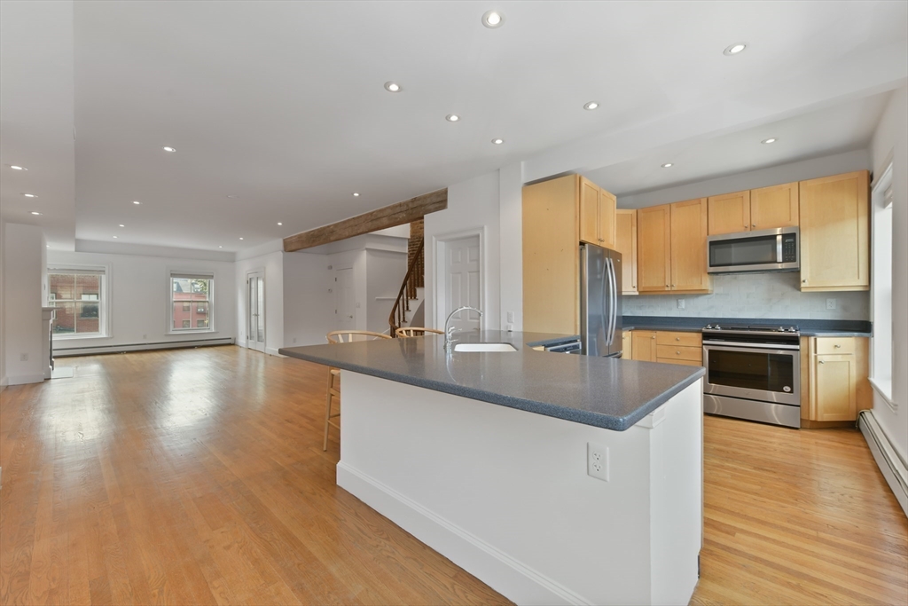 71 Rutland Street, Unit 4 Boston, MA 02118 - Photo 2 of 35 a kitchen with stainless steel appliances granite countertop a sink a stove and a wooden floors