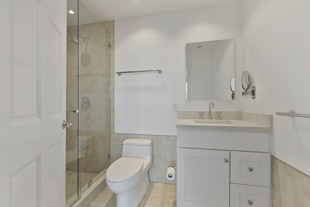 71 Rutland Street, Unit 4 Boston, MA 02118 - Photo 22 of 35 a bathroom with a toilet sink vanity and mirror