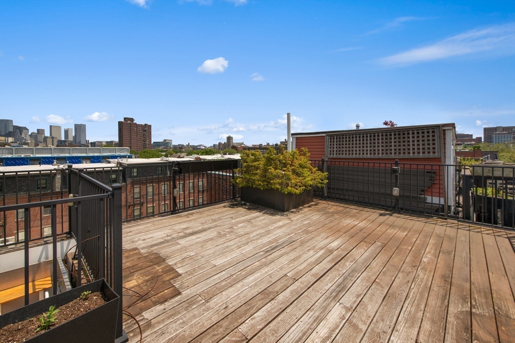 71 Rutland Street, Unit 4 Boston, MA 02118 - Photo 30 of 35 a view of a terrace with wooden floor and city view