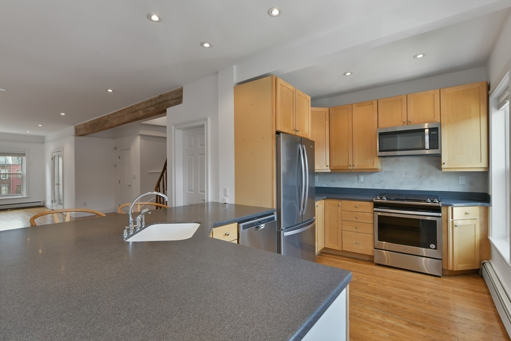 71 Rutland Street, Unit 4 Boston, MA 02118 - Photo 7 of 35 a kitchen with stainless steel appliances a stove refrigerator sink and cabinets