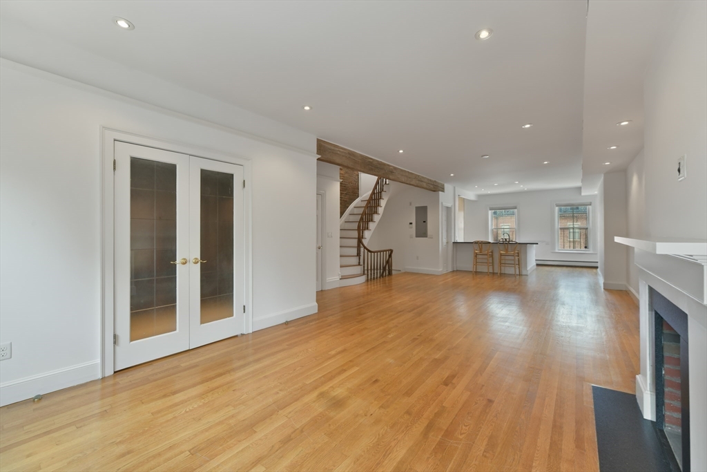 71 Rutland Street, Unit 4 Boston, MA 02118 - Photo 9 of 35 a view of empty room with wooden floor and kitchen