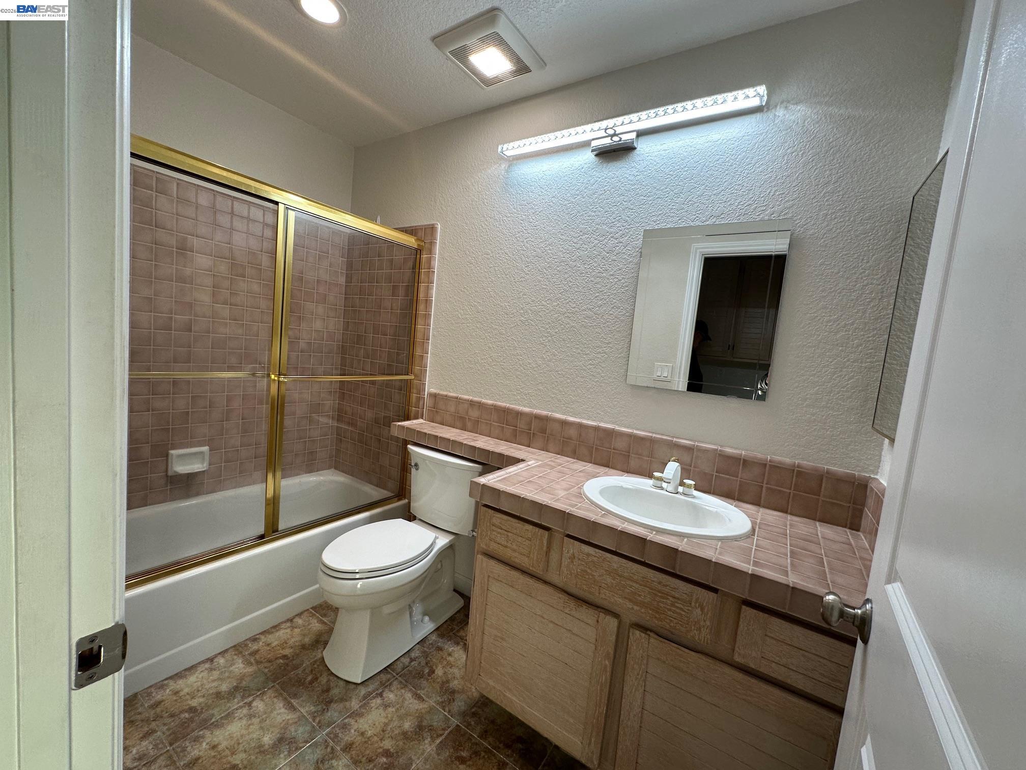 912 Vista Pointe Drive San Ramon, CA 94582 - Photo 12 of 13 a bathroom with a granite countertop toilet a sink and a mirror