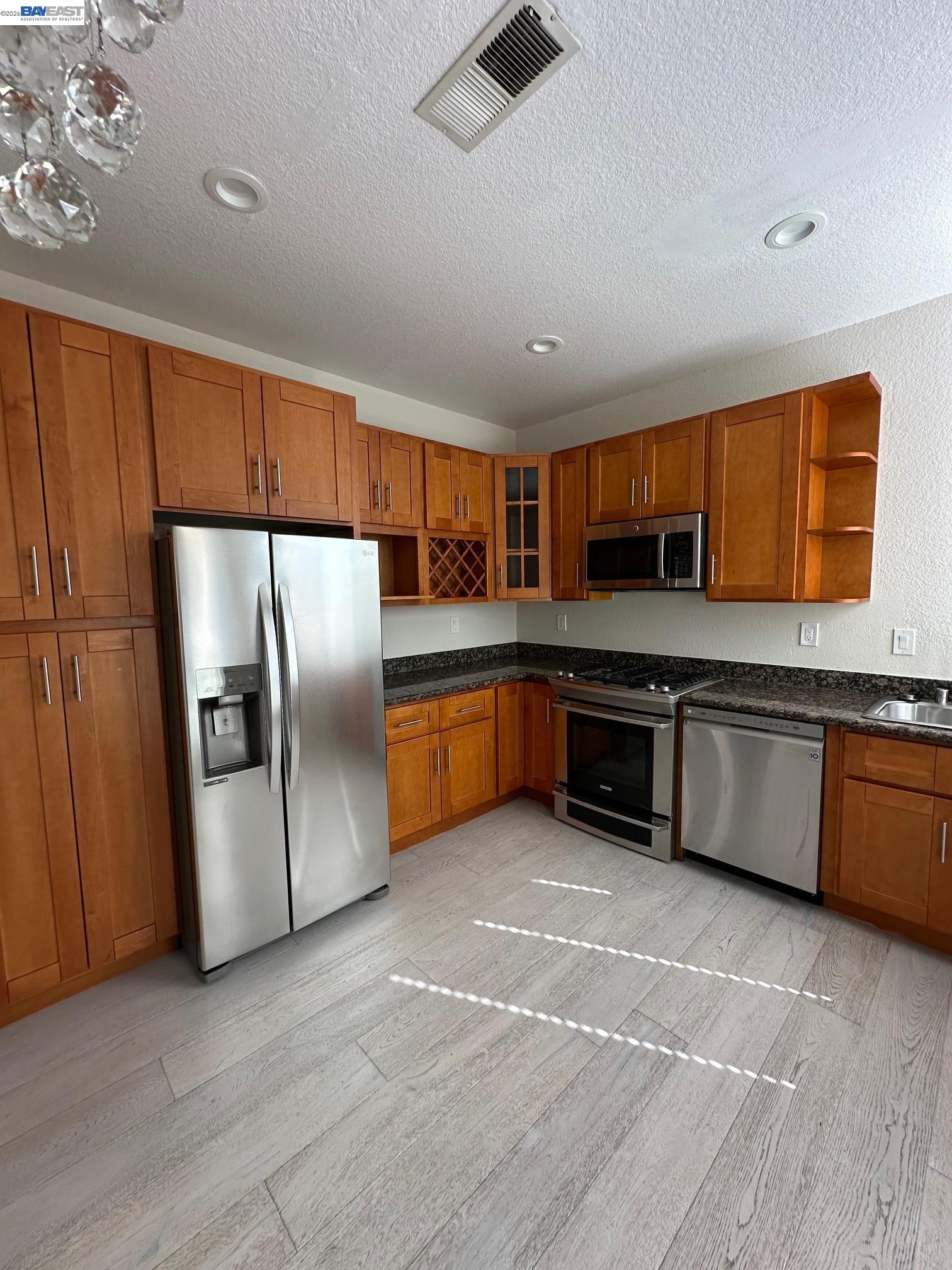 912 Vista Pointe Drive San Ramon, CA 94582 - Photo 4 of 13 a large kitchen with stainless steel appliances granite countertop a stove a sink dishwasher a refrigerator and a microwave oven