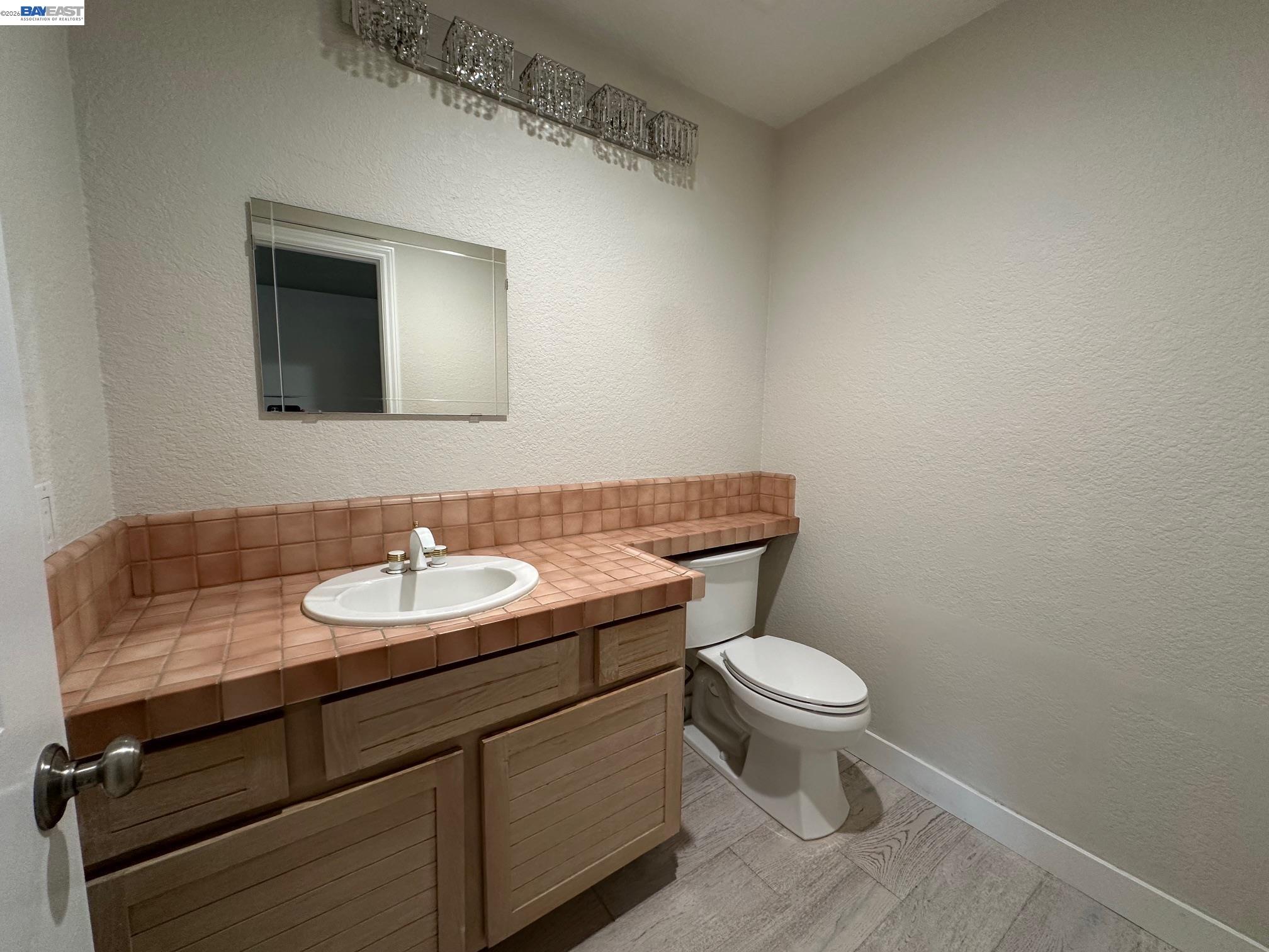 912 Vista Pointe Drive San Ramon, CA 94582 - Photo 5 of 13 a bathroom with a toilet a sink and mirror
