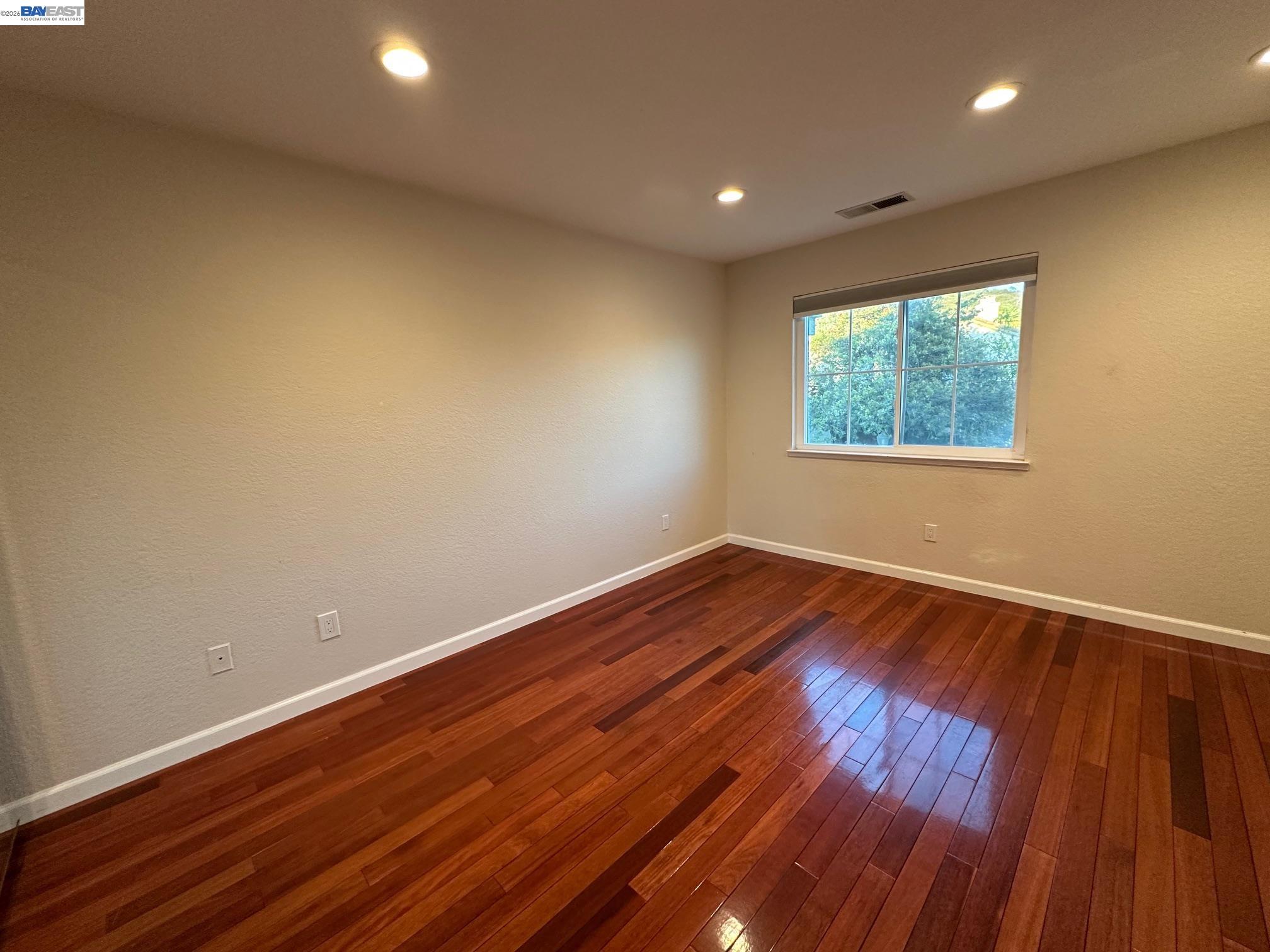 912 Vista Pointe Drive San Ramon, CA 94582 - Photo 8 of 13 a view of an empty room with wooden floor and a window
