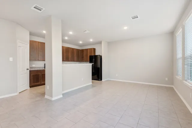 an empty room with closet and windows