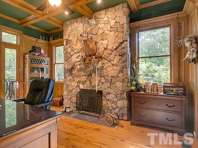 9100 Honeycutt Road Raleigh, NC 27615 - Photo 14 of 25 a room with chair and wooden floor