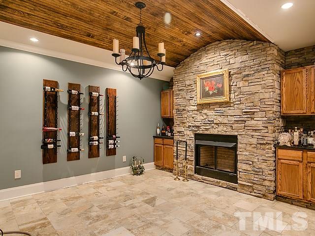 9100 Honeycutt Road Raleigh, NC 27615 - Photo 22 of 25 a view of a livingroom with a fireplace and cabinets