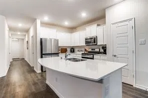 a kitchen with a sink and refrigerator