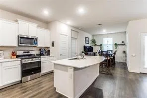 a kitchen with a sink cabinets and wooden floor