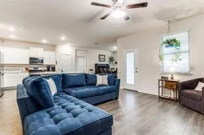 a living room with furniture and kitchen view