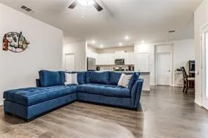a living room with a couch and a view of kitchen