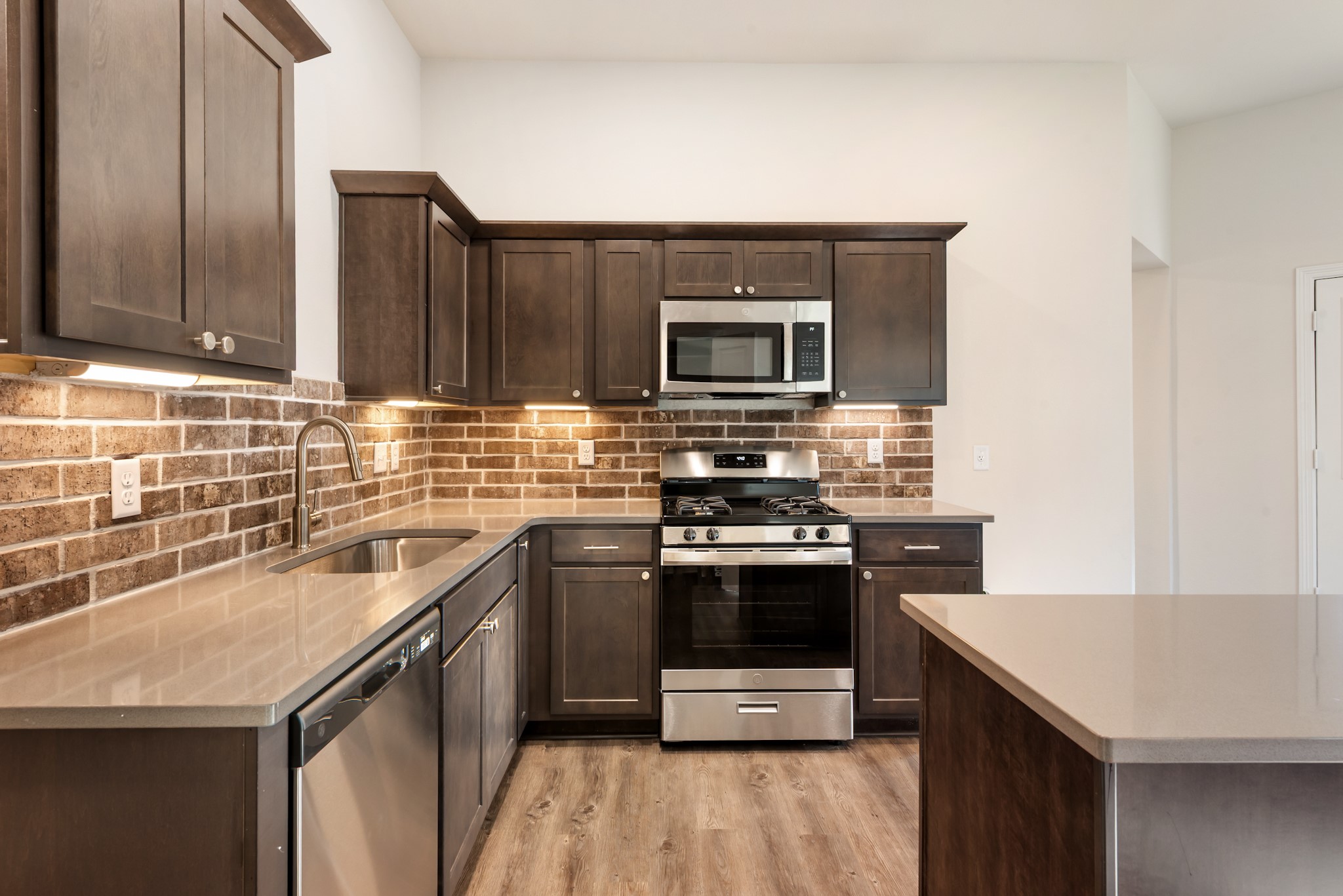 1214 High Street Navasota, TX 77868 - Photo 14 of 28 a kitchen with stainless steel appliances granite countertop a sink stove and microwave