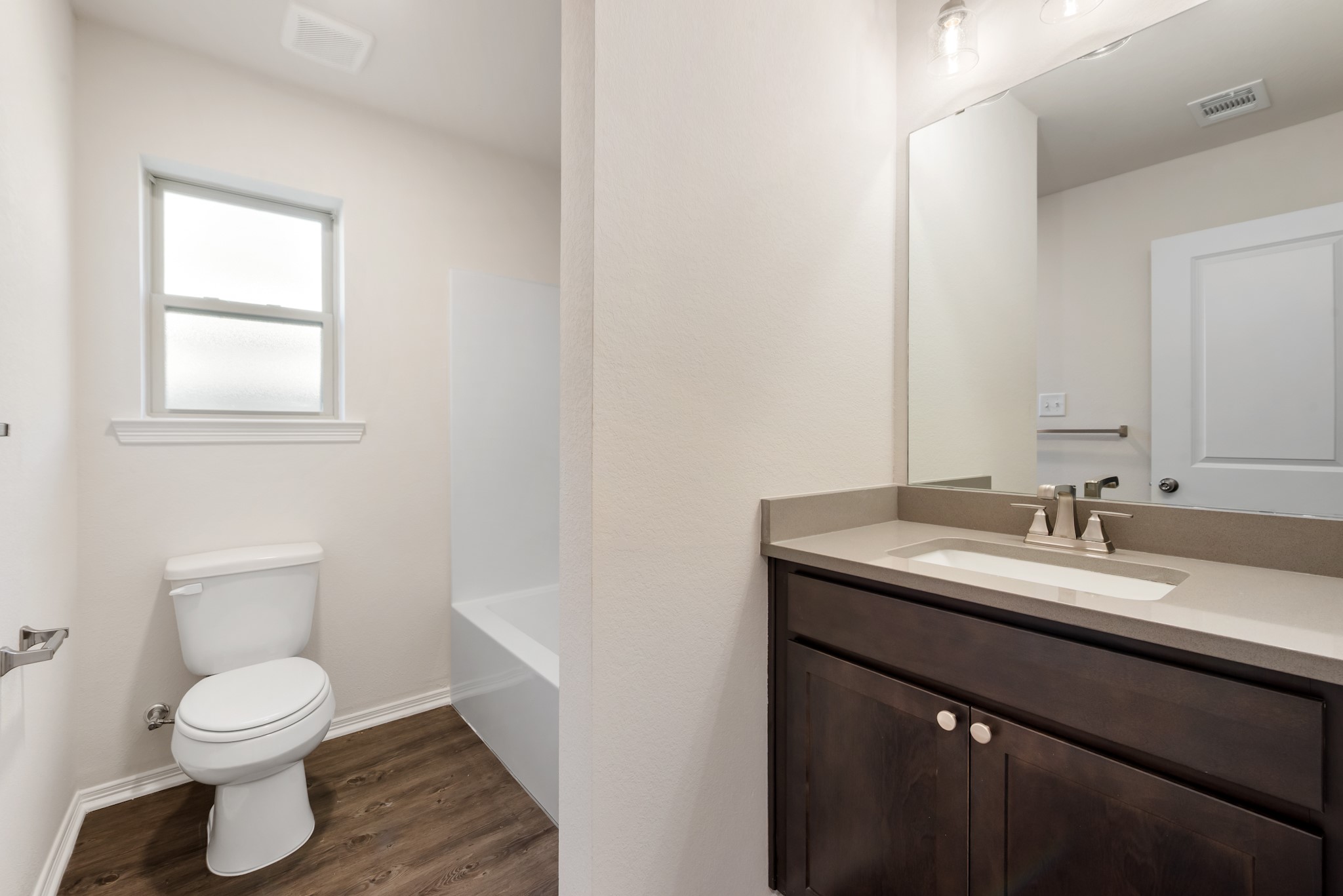 1214 High Street Navasota, TX 77868 - Photo 19 of 28 a bathroom with a granite countertop sink toilet and mirror