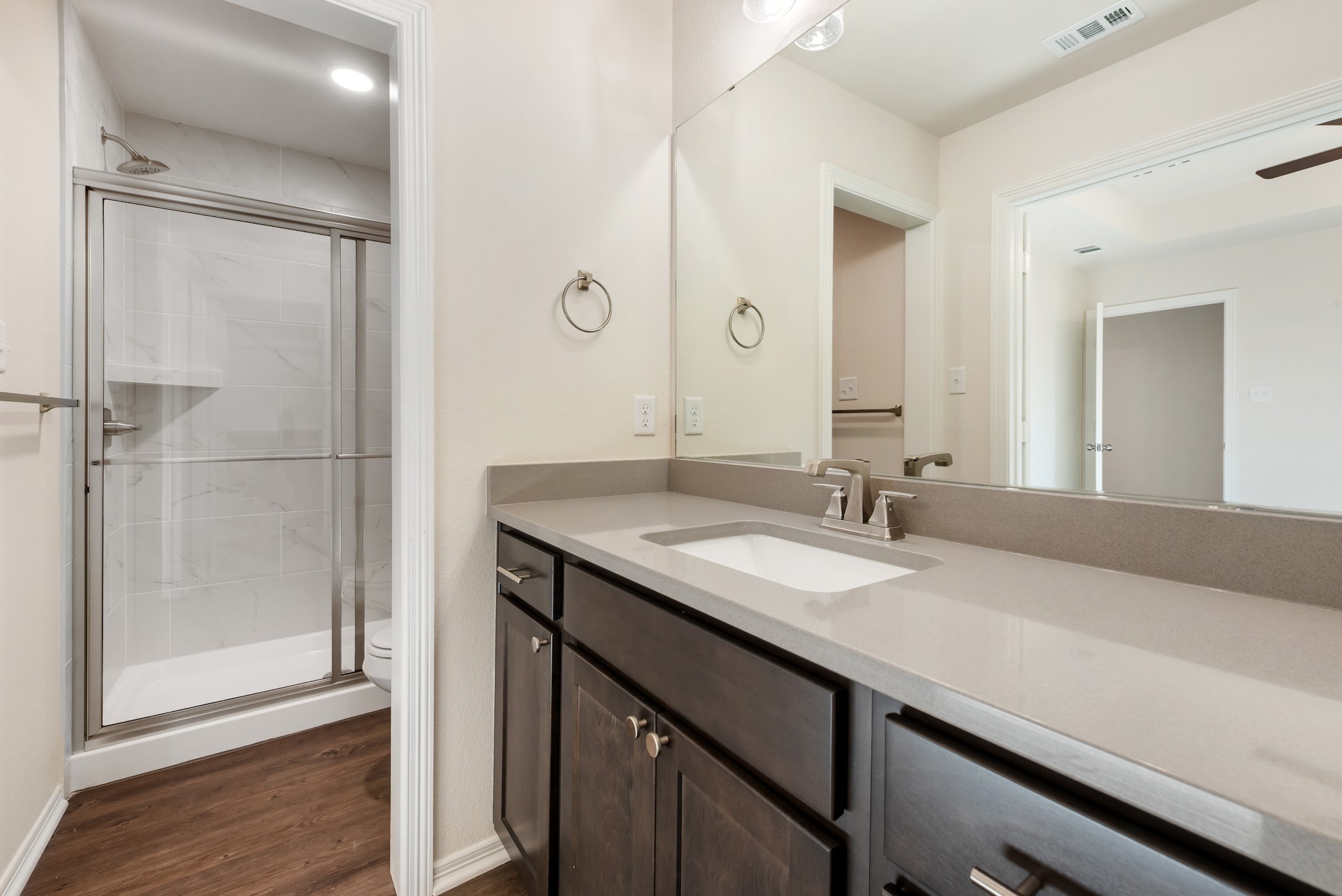 1214 High Street Navasota, TX 77868 - Photo 24 of 28 a bathroom with a granite countertop sink a mirror and a shower