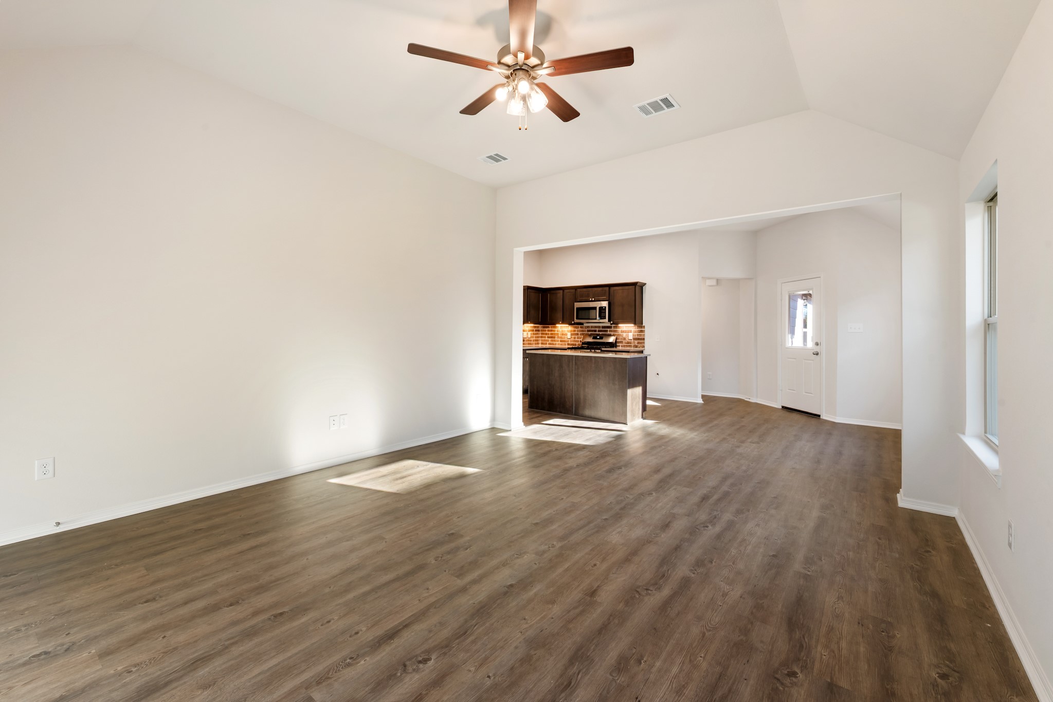 1214 High Street Navasota, TX 77868 - Photo 6 of 28 wooden floor in an empty room with a window