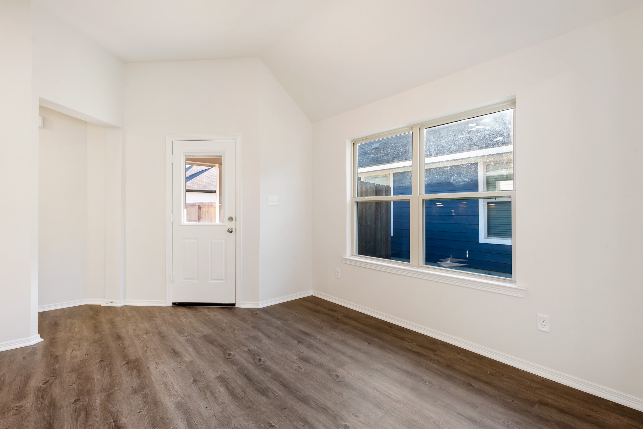 1214 High Street Navasota, TX 77868 - Photo 10 of 28 a view of an empty room with wooden floor and a window