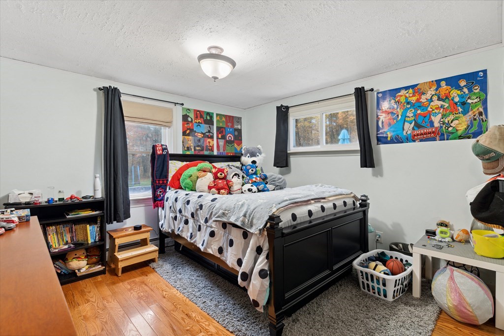 39 Duval Road Sutton, MA 01590 - Photo 16 of 24 a bedroom with a bed and a painting on the wall