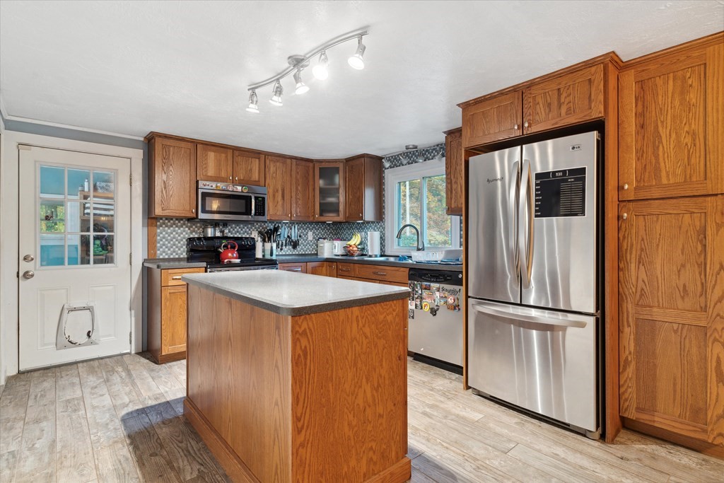 39 Duval Road Sutton, MA 01590 - Photo 7 of 24 a kitchen with stainless steel appliances granite countertop a refrigerator stove microwave and sink