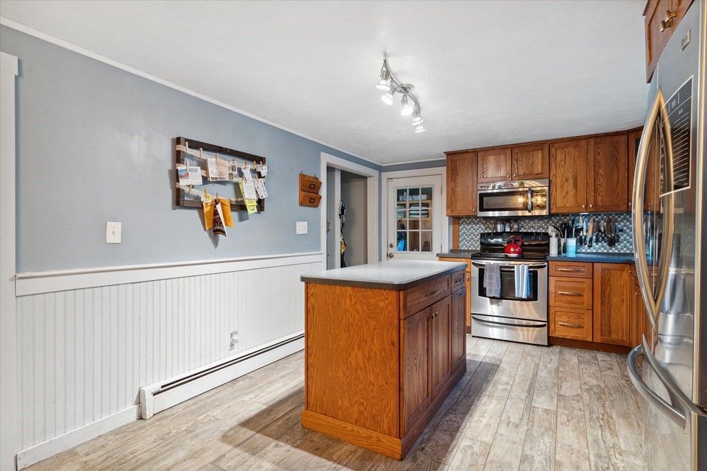 39 Duval Road Sutton, MA 01590 - Photo 8 of 24 a kitchen with stainless steel appliances granite countertop a stove top oven a sink dishwasher and wooden cabinets