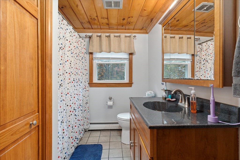 39 Duval Road Sutton, MA 01590 - Photo 10 of 24 a bathroom with a granite countertop sink and a mirror
