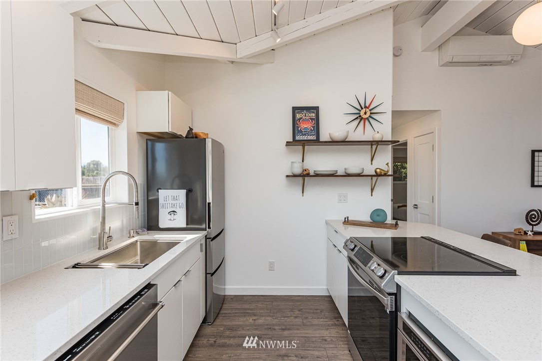 271 3 Crabs Road Sequim, WA 98382 - Photo 12 of 40 a kitchen that has a sink and a stove