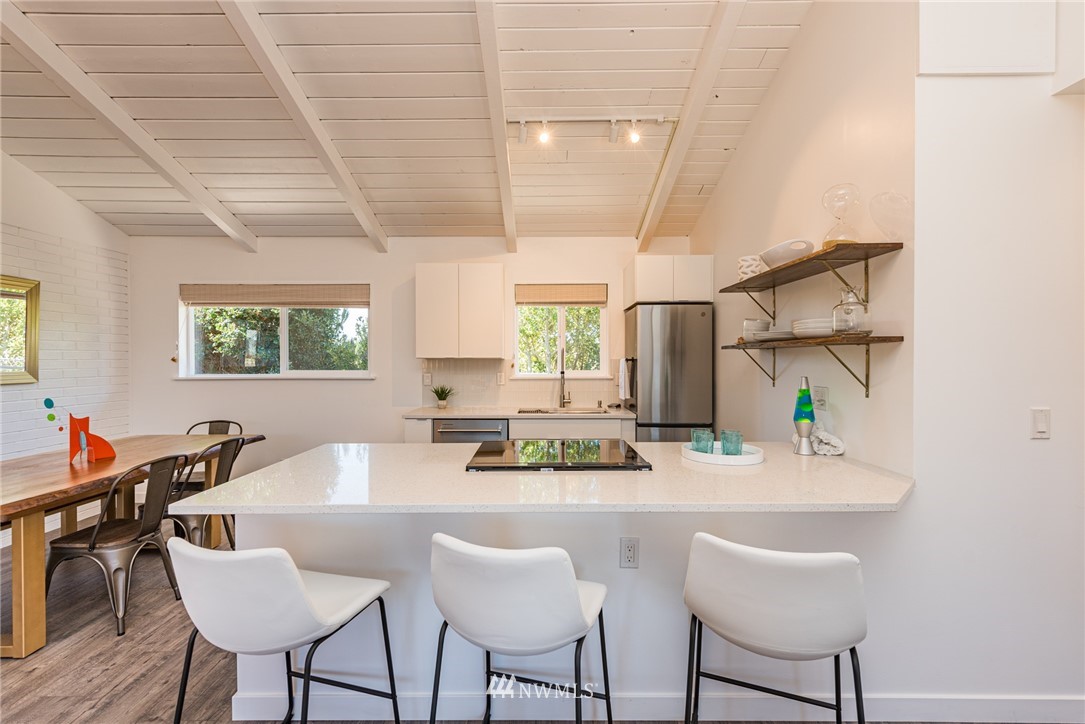 271 3 Crabs Road Sequim, WA 98382 - Photo 34 of 40 a kitchen with stainless steel appliances kitchen island granite countertop a sink and a refrigerator