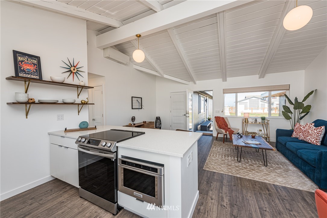 271 3 Crabs Road Sequim, WA 98382 - Photo 7 of 40 a view of a kitchen with a stove and a wooden floor