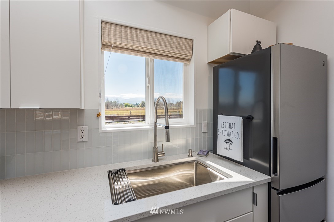 271 3 Crabs Road Sequim, WA 98382 - Photo 10 of 40 a kitchen with stainless steel appliances granite countertop a refrigerator and a sink
